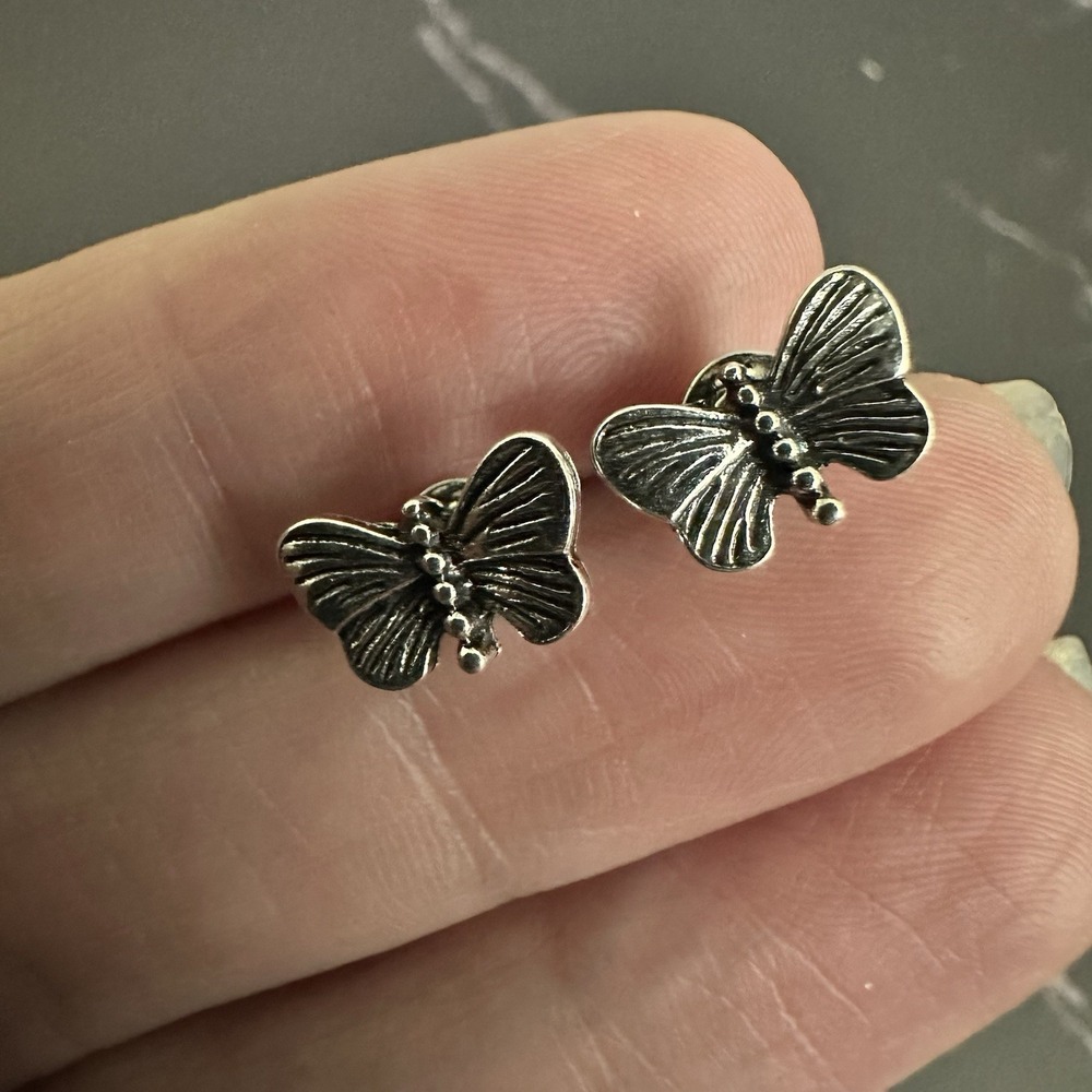 pair of detailed silver-toned butterfly stud earrings